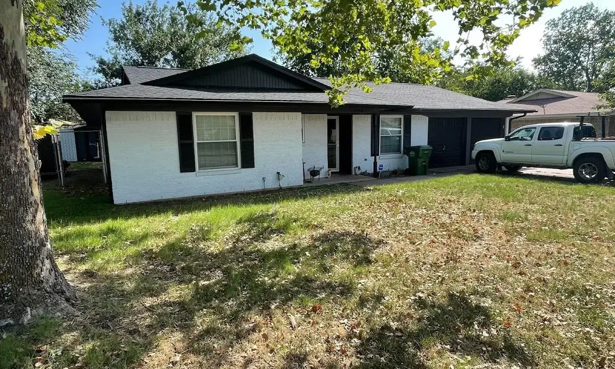 Professional roofing crew working on a residential roof in Garland